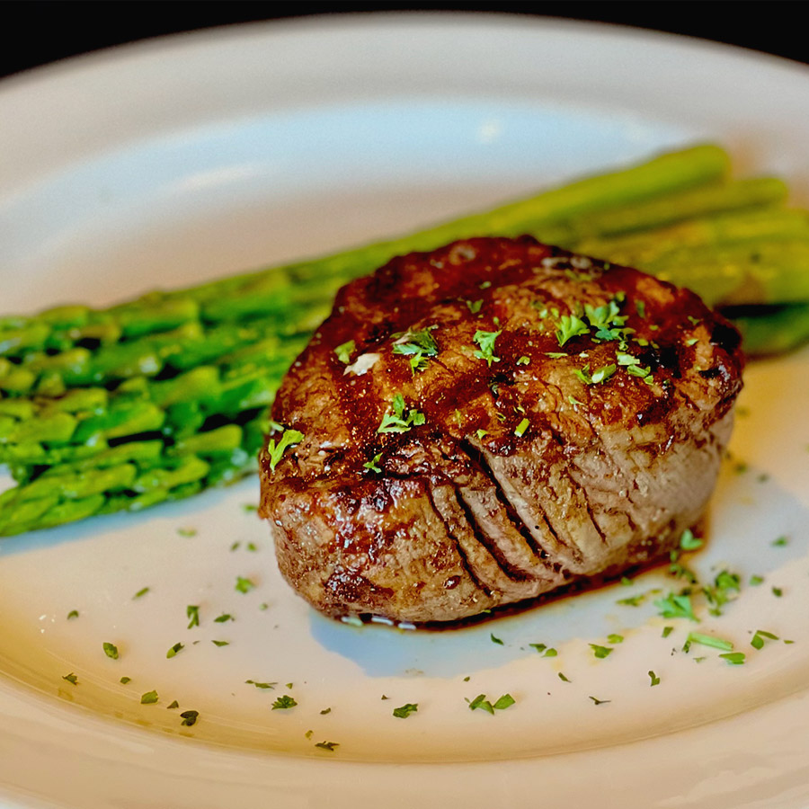 Seared filet mignon plat4ed with bright green asparagus