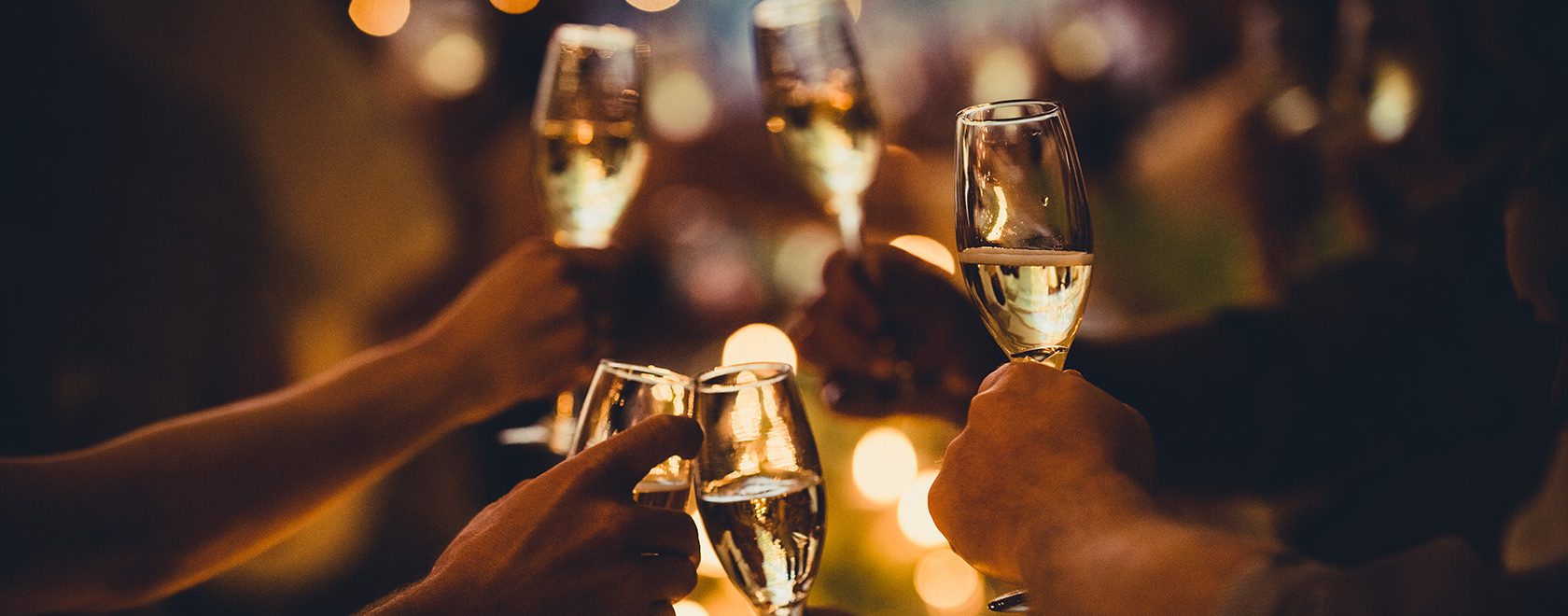 Group toasting with filled champagne glasses