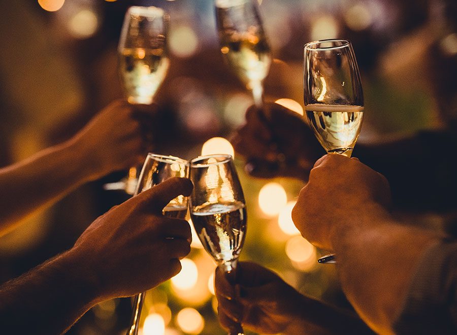 Group toasting with filled champagne glasses