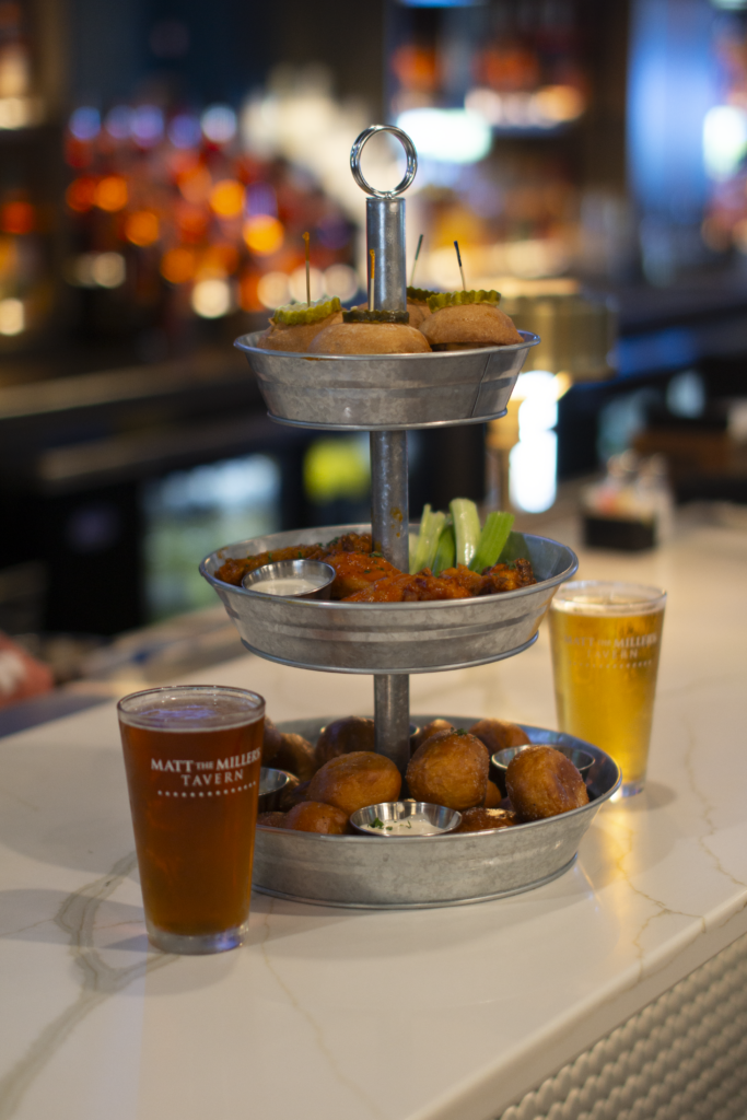The Tailgate Tower: three tiers of sliders, wings and pretzel bites with two beers on the bar